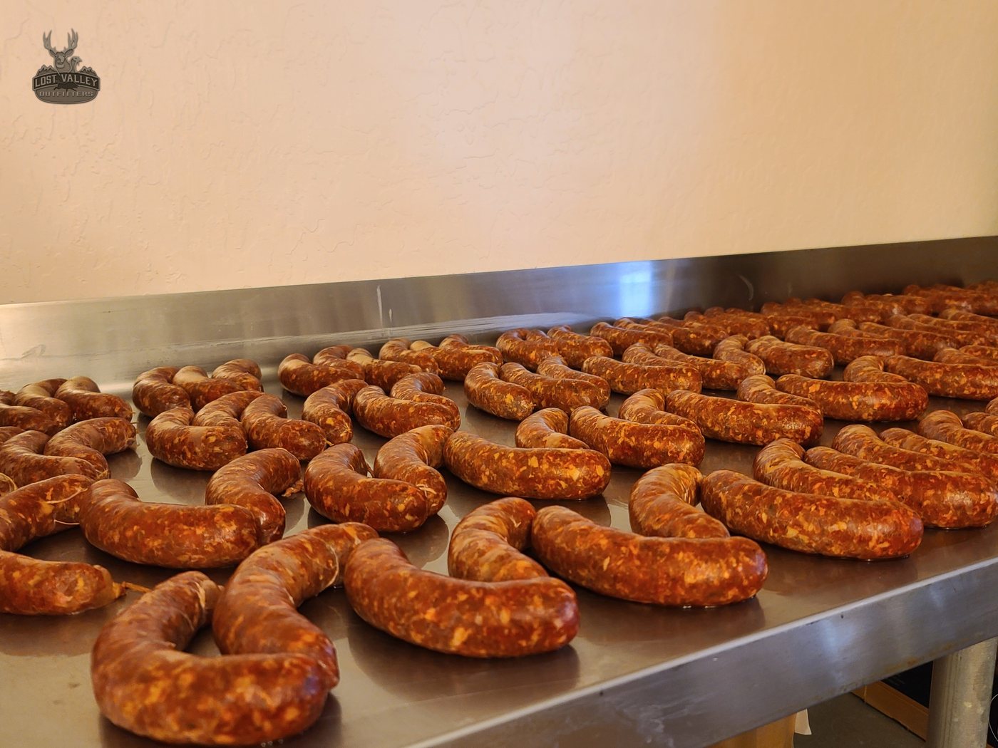 Fresh sausage links laid out in the Lost Valley Outfitters processing room