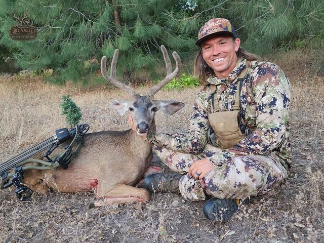 Hunter with a management blacktail buck
