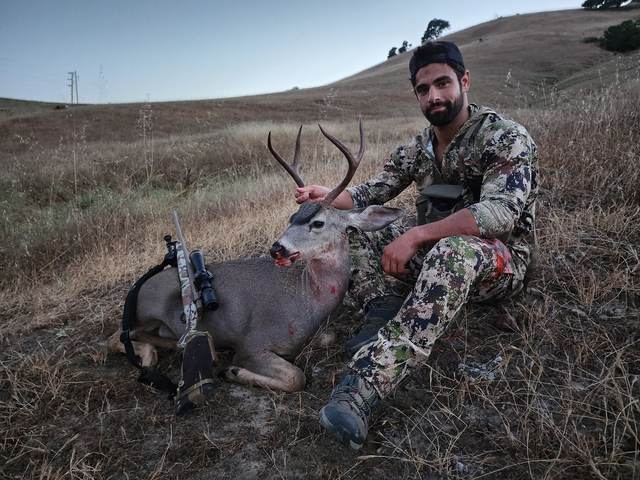 Hunter with a management blacktail buck