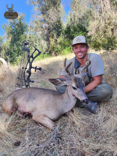 Hunter with a management blacktail buck