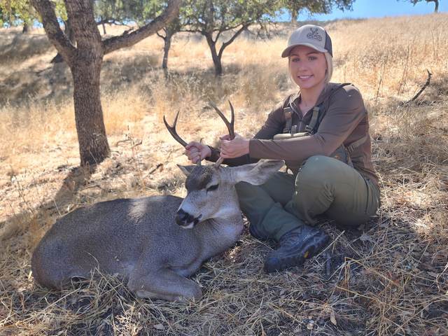 Hunter with a management blacktail buck