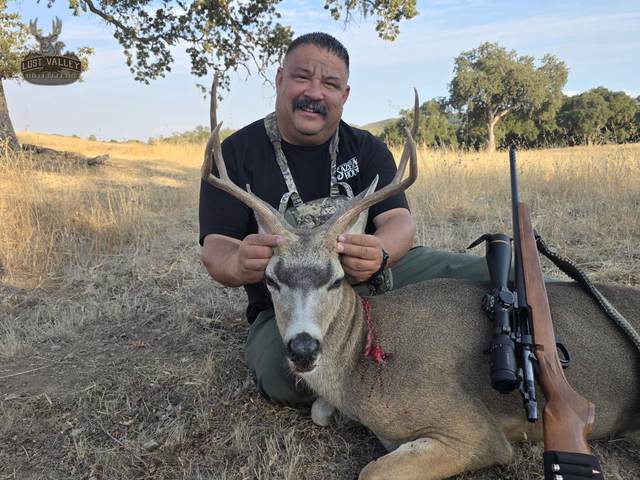 Hunter with a management blacktail buck