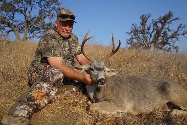 Hunter with a management blacktail buck