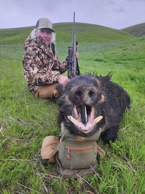 Hunter with a Central Coast wild pig taken on a guided rifle hunt